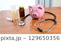 Image of medical expenses using a stethoscope and a piggy bank 129650356