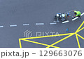 Yellow rectangular sign prohibiting parking on asphalt. Highway crosswalk work. Applying road marking 129663076