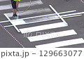 Highway crosswalk working. Applying road markings. Paint a pedestrian crossing with white color 129663077