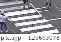 Applying road markings. Paint a pedestrian crossing with white paint. 129663078