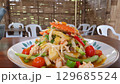 Fresh Seafood Salad with Colorful Vegetables and Spicy Dressing 129685524