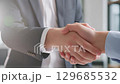 Diverse Team Collaborating in Hybrid Meeting with Video Conference Setup 129685532