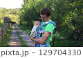 Father Holding Baby on Outdoor Pathway 129704330