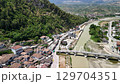 Flying over tiled roofs of houses, mosques and minarets in Berat, Albania. Magnificent Ottoman buildings in the most beautiful city of Albania - Berat. Aerial view, 4K 129704351