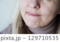 Thoughtful caucasian mature woman bites lip in contemplation across three frames 129710535