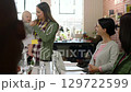 Business woman, mother and speaker with a baby speaking at a office marketing team meeting. Working mom manager give a digital advertising presentation with her child and staff at her startup company 129722599