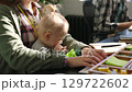 Office business woman, mother with baby and working typing at computer desk, KPI document report for workflow management. Inclusion, western corporate mom and kid in workplace with employee paperwork 129722602