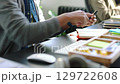 Businessman writing notes, reading documents report and doing creative research on a computer. Corporate, professional and expert manager planning a management strategy with paperwork and technology. 129722608