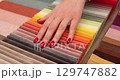 Female hand runing over multicolored fabrics in workshop 4k movie 129747882