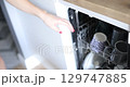 Woman washing dishes from dishwasher 4k movie 129747885