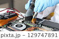 Hands in rubber gloves scratching laptop with vacuum cleaner and brush 4k movie 129747891