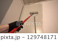 A professional who paints walls gray with a paint roller. Apartment painting, renovation. There is a place to copy. High quality 4k footage 129748171