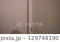 A man paints a wall with a nap roller. Close-up of movement along the wall. Apartment renovation. High quality 4k footage 129748190