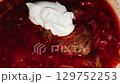 Traditional borscht soup with beetroot, meat, and sour cream topping 129752253