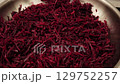 Grated beetroot in bowl as ingredient for borscht soup 129752257