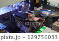 Robotic process of installing components, LED diodes on LED board. High-tech, robotic equipment, machine for production of LEDs at factory for production of LED lamps, lighting devices. Close-up. 129756033