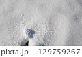 Winter adventure: solo journey of a young adult's footsteps in pristine snow 129759267