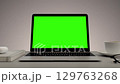 Greenscreen display on laptop set on white table. Home office workspace. Close up of chroma key on screen for Video Call, Website Template Presentation Game Applications. Freelance Business. Zoom in 129763268