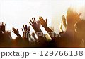 Christians raising their arms, praising, praying, and worshipping, a background of a church gathering filled with the Holy Spirit, and a cheering crowd concept. 129766138
