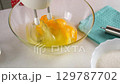 Woman chef hands whisking eggs with electric mixer, baking preparation. 129787702
