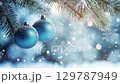 Blue Christmas baubles with a frosted finish hang from snow-covered pine branches in a serene winter scene. zoom in, zoom out, pan, or 360 degree shot, animate 129787949