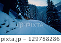 Aerial View of Winter Wonderland: Snow-covered Mountains. Allure of snowy landscapes, mountain retreats, winter tourism, and picturesque charm. zoom in, zoom out, pan, or 360 degree shot, animate 129788286