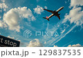 Airplane soaring above signage with vibrant sky and clouds. Sign Next stop 2026 and airplan in the sky. Happy New Year. Merry Christmas 129837535