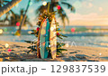 Tropical holiday vibes: festive surfboard and palm trees on sunny beach. Happy New Year. Merry Christmas.  129837539
