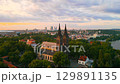 Experience the breathtaking sunrise illuminating the Vysehrad Basilica of St. Peter and St. Paul in Prague. Witness the serene atmosphere and panoramic views of the city as morning light breaks. 129891135