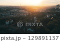 Witness the breathtaking sunrise casting golden light over the iconic Vysehrad Basilica of St. Peter and St. Paul in Prague. The serene morning ambiance highlights this historic site beautifully. 129891137