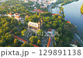 Experience the breathtaking beauty of Vysehrad Basilica of St. Peter and St. Paul as the sun rises over Prague. Marvel at the stunning architecture and lush surroundings in this morning view. 129891138