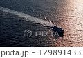 Majestic boat gliding across shimmering waters at sunset, creating a tranquil escape in nature's embrace 129891433