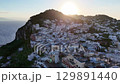 Beautiful sunrise over the charming village of Capri, showcasing stunning architecture and serene coastal views early in the morning 129891440