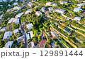 Vibrant hillside community embraces nature's beauty in a serene landscape during golden hour 129891444