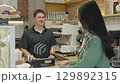 Customer Ordering Coffee While Reading Menu At Cozy Modern Cafe Counter 129892315