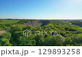 Discover the stunning landscape of Velka Amerika, an abandoned limestone quarry near Prague, showcasing lush greenery and impressive rock formations under the bright sun. 129893258