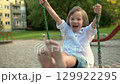 Adorable little boy having fun on a playground on bright sunny summer day. 129922295