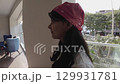 Latina Teen Girl Enters Living Room After Looking Out from Balcony 129931781