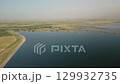 Aerial view of reservoir dam, farmlands and agricultural landscape near Djizak 129932735