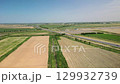 Aerial view of Uzbekistan highway with green farmlands nearby 129932739