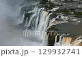 Aerial view of Iguazu Falls with powerful cascades and thick clouds of mist 129932741