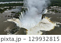Iguazu Falls thundering over cliffs with islands and forest in the background 129932815