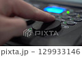 Close-up of finger adjusting Tilt shuttle on lighting console 129933146