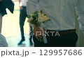 Man walking with wedding bouquet. 129957686