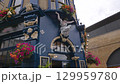 Colorful flowers on blue facade of historic London pub 129959780