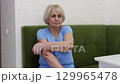 Elderly woman massaging her arm with a massage ball 129965478