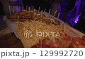 French fries, sandwiches and snacks for guests at evening party. 129992720