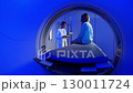 Handsome Caucasian Doctor talking to patient before MRI. Portrait patient talking about symptoms before tomography. Patient sitting at CT scanner doctor adjusting MRI capsule. Conducting advanced 130011724
