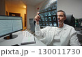 Medic expert holding x ray imaging test results. Handsome Caucasian male reviewing diagnostic results. Concentrating inside radiology room. Neuroscientist Finding Treatment X-ray Scan MRI CT Scan 130011730
