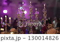 Elegant oil candles burning in banquet hall. 130014826